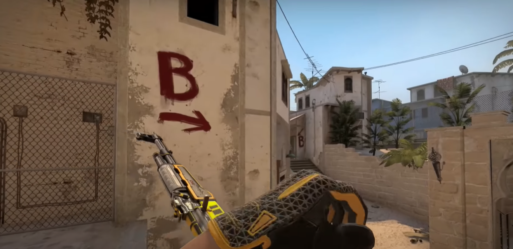 CS:GO game with a character's hand holding a gun