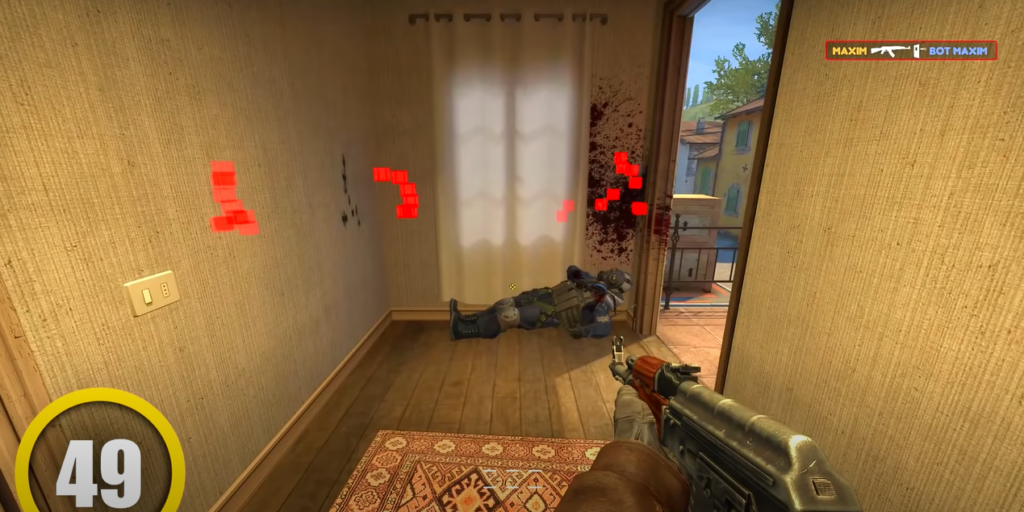 One character holding a gun while another character lies on the floor